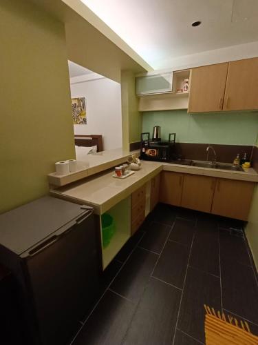 a kitchen with a sink and a counter top at OMAR BB STUDIO in Kota Bharu
