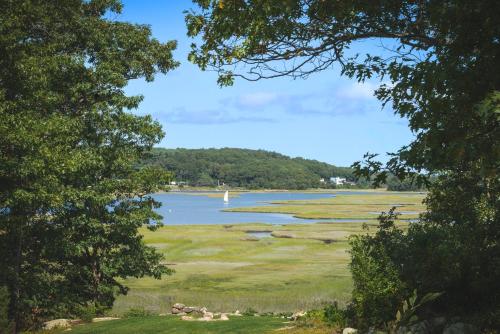 a view of a lake with a boat in the water at PREMIUM PROPERTY - Private 2-Acre Retreat - MODERN 4 Bedrooms - See Video Tour in Gloucester