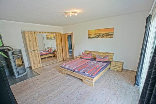 a bedroom with a bed and a fireplace at Nebengebäude in Mönkebude