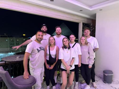 a group of people in white shirts posing for a picture at Unique Pyramids Boutique INN in Cairo