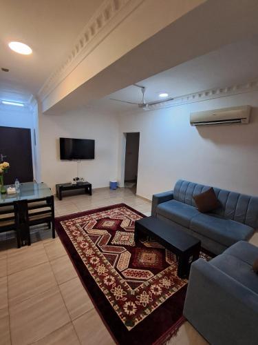 a living room with a couch and a table at Gateway Salalah hotel apartments in Salalah