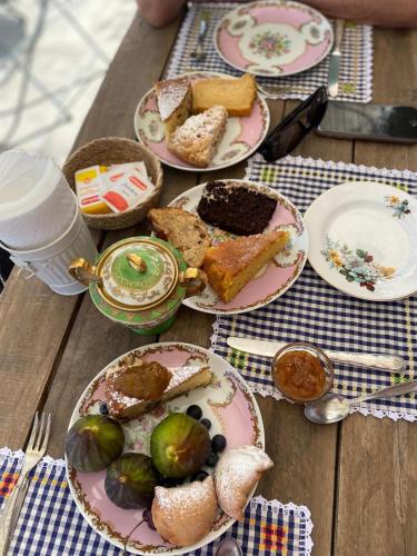 a wooden table with plates of food on it at Bàcula Nzícula Marzamemi in Marzamemi