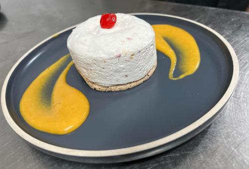 a piece of cake on a blue plate with two bananas at La Sapinière St Lary Soulan in Saint-Lary-Soulan