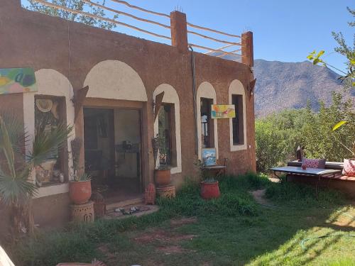 a small house with plants in the yard at Riad dar idsalah in Ouirgane