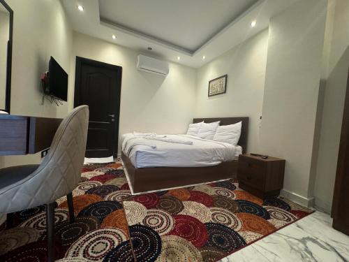 a small bedroom with a bed and a rug at Unique Pyramids Boutique INN in Cairo