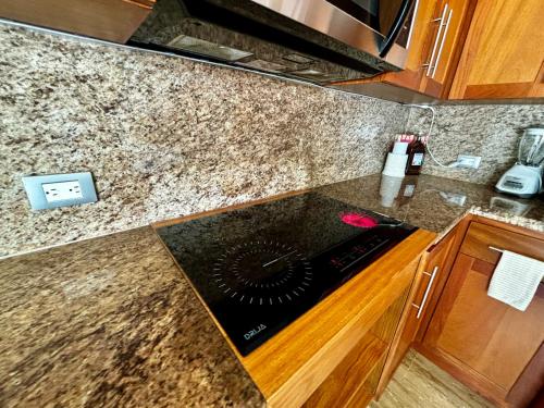 a kitchen with a counter top with a stove at Residencial Mañanero in Cabarete