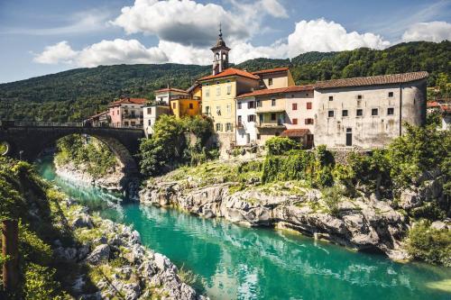 a town on a hill next to a river at Piuma apartment in Gorizia