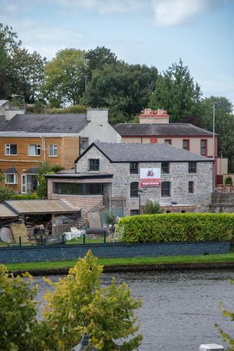 a building next to a body of water at Waterfront View Apartment in Carrick on Shannon