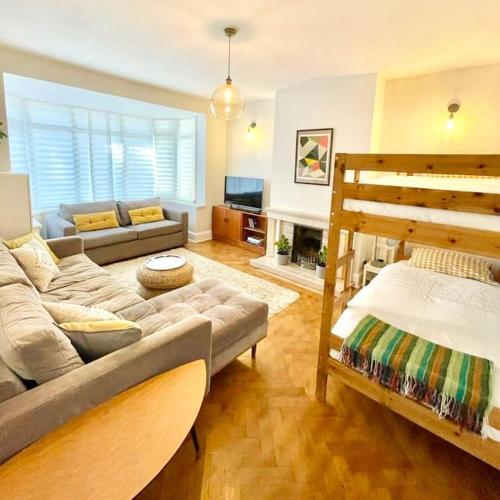 a living room with a couch and a bed at Flat1Hove- renovated, 2BR, patio, beach, free onsite parking in Hove