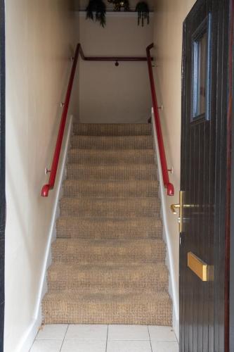 a set of stairs in a hallway with a door at Waterfront View Apartment in Carrick on Shannon