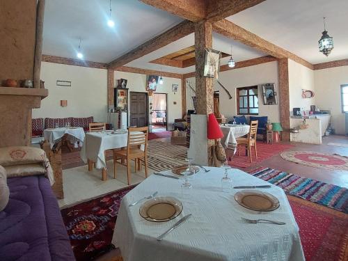 a living room with a table with plates on it at Riad dar idsalah in Ouirgane