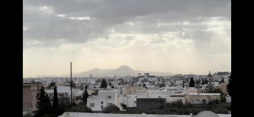a view of a city with a mountain in the background at Guesthouse with City View and Terrace in Jafar