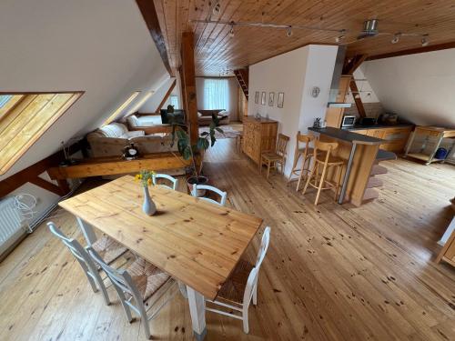a large room with a wooden table and chairs at Ferienhof Schmetterlingsgarten in Jakobshagen