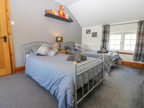 En eller flere senge i et værelse på Moorhen House