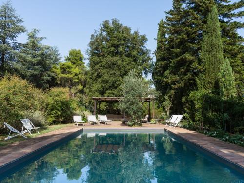 einen Pool mit zwei Stühlen und einem Pavillon in der Unterkunft Villa Il Giardino Di Eugenia by Interhome in Viceno