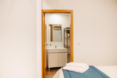 a bathroom with a sink and a mirror at Alvarenga Apartments in Alvarenga