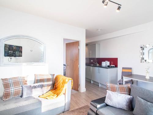 a living room with a couch and a table at The heart of Huddersfield hideaway in Huddersfield