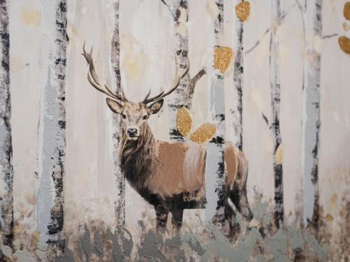 a painting of a deer on a wall at Holiday Home Springbank Lodge by Interhome in Drumnadrochit