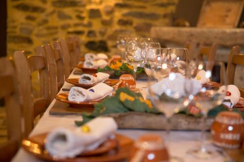a table with plates of food and wine glasses at Casas do Terreiro in Seia