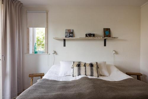 a bedroom with a bed and a window at Siggesta Gård in Värmdö