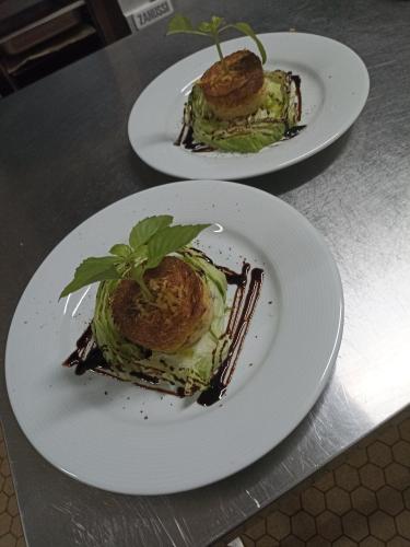 two plates of food on top of a table at La Sapinière St Lary Soulan in Saint-Lary-Soulan