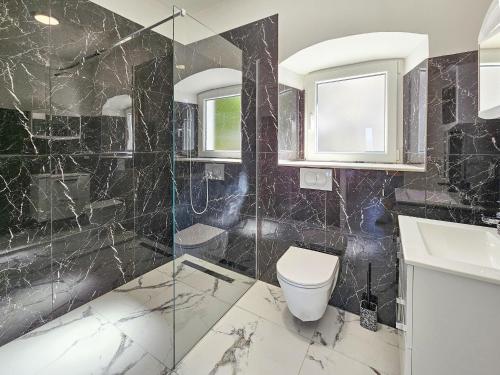 a bathroom with a toilet and a glass shower at Holiday Home Sunrise by Interhome in Janjina