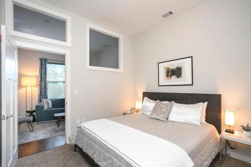 a bedroom with a bed and a desk and a chair at Music Row w Free Parking in Nashville