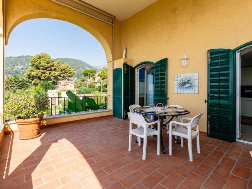 a patio with a table and chairs and a view at Apartment Loggia sul mare by Interhome in Latte