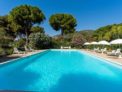 a large swimming pool with chairs and umbrellas at Apartment Loggia sul mare by Interhome in Latte