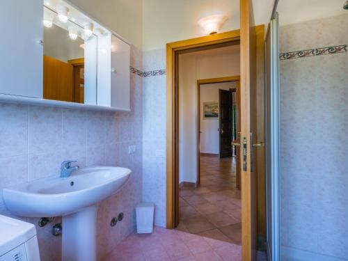 a bathroom with a sink and a mirror and a shower at Holiday Home Oliveta 2 by Interhome in Fiorino
