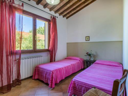 two beds in a room with a window at Holiday Home Oliveta 2 by Interhome in Fiorino