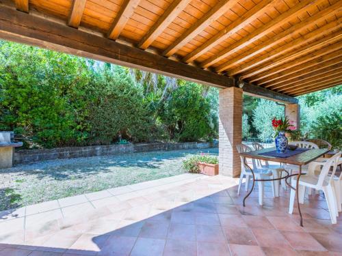 a patio with a table and chairs under a wooden pergola at Holiday Home Oliveta 2 by Interhome in Fiorino