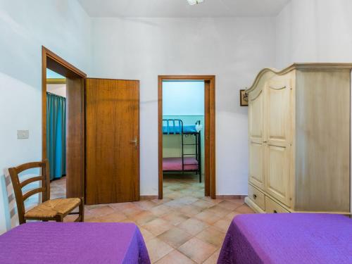 a room with two purple beds and a room with a bedroom at Holiday Home Oliveta 1 by Interhome in Fiorino