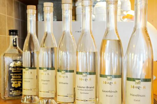 a group of wine bottles sitting on a counter at Wildkräuter-Gasthof Linde in Löffingen