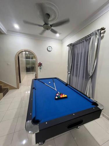 a blue pool table in a room with a ceiling at Family choice Ling53 in Sitiawan