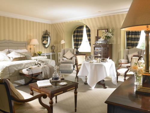 a living room with a bed and a table at Hayfield Manor in Cork