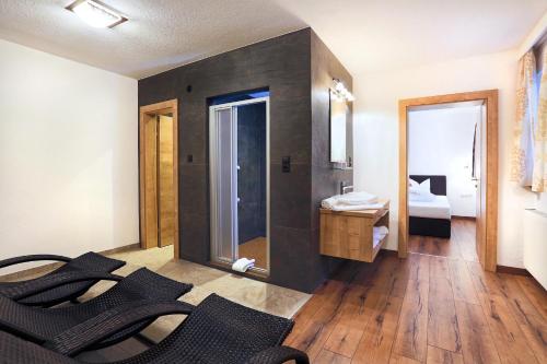 Habitación con baño con lavabo y espejo. en A CASA Rubin Chalet & Studio Resort, en Sölden