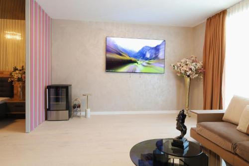 a living room with a couch and a painting on the wall at Cozy Constellations in Poiana Brasov