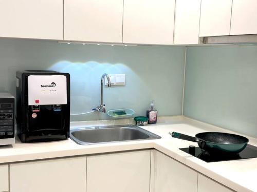 a kitchen counter with a sink and a stove at Mansion One Modern 5pax walking distance Gleneagles Hospital Gurney Plaza in George Town