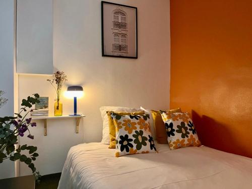 une chambre avec un lit avec des oreillers dessus dans l'établissement Fully equipped Studio at 3 mins from metro, à Paris
