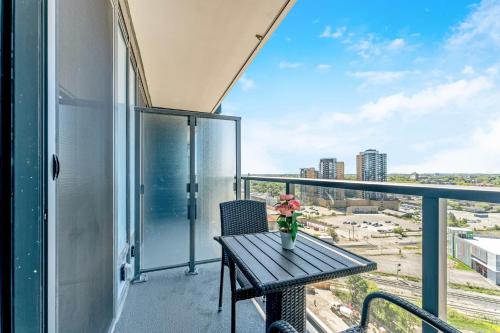 a balcony with a table and a view of the city at Modern High Rise King bed Condo with Private Balcony in Kitchener