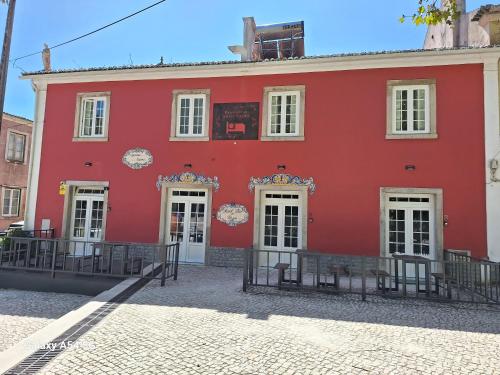 a red building with white doors and windows at AL Penaferrim Sintra Rooms in Sintra