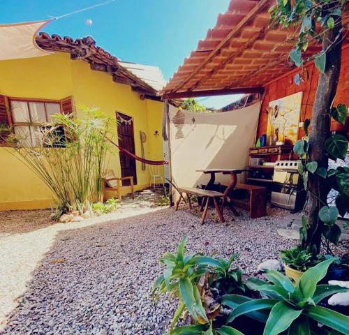 an outdoor patio with a table and a tent at Casa Solar in Alto Paraíso de Goiás
