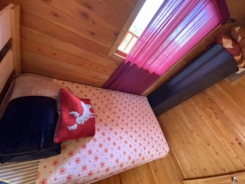 a room with a bed in a tiny house at Cabaña Tulipanes - COZY cabin in an awesome place! in Jardín
