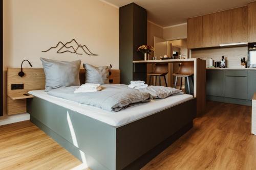 Cette chambre comprend un grand lit et une cuisine. dans l'établissement Harzchalet Emma 3 - mit Sauna - Sankt Andreasberg, à Sankt-Andreasberg