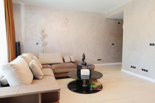 a living room with a couch and a table at Cozy Constellations in Poiana Brasov