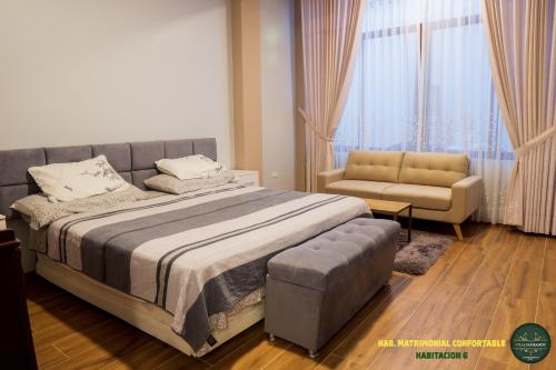 a bedroom with a bed and a couch and a chair at Villa San Ramon - BIG HOUSE - Chamchamayo in San Ramón