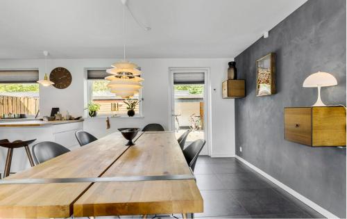 a dining room with a wooden table and chairs at Wellness House in Frederikssund