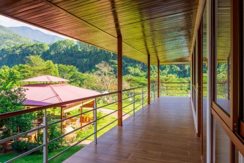 a balcony of a house with a view of the mountains at Villa San Ramon - BIG HOUSE - Chamchamayo in San Ramón