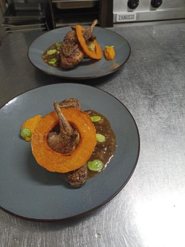 two plates of food on top of a counter at La Sapinière St Lary Soulan in Saint-Lary-Soulan